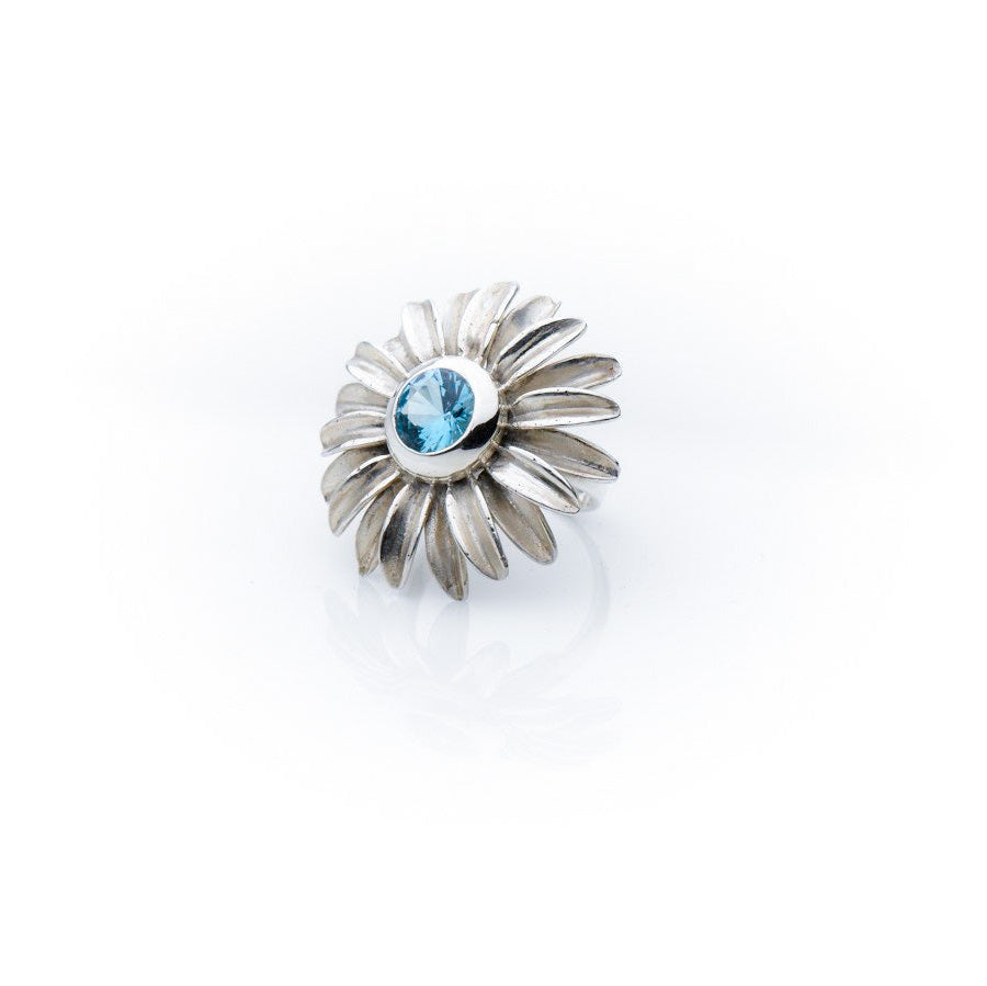 Silver daisy ring with topaz centre